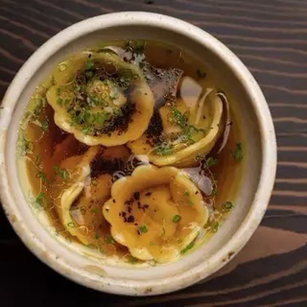 A dish of tortellini en brodo at Enclos in Sonoma, Calif., made with black truffles and chives.