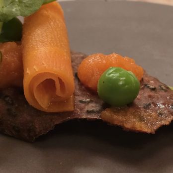 L'Ecu - Close up of fresh rye bread crust + shaved poached carrots + peas on top of gazpacho - Swiss Food Near Me - Bulle, FR L'Ecu - Close up of fresh rye bread crust + shaved poached carrots + peas on top of gazpacho - Swiss Food Near Me - Bulle, FR