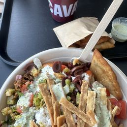 Chicken bowl with pita chips and a blueberry lavender beverage