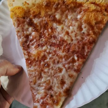 Supreme Pizza - a slice of pizza on a paper plate - Pizza Near Me - Brooklyn, New York