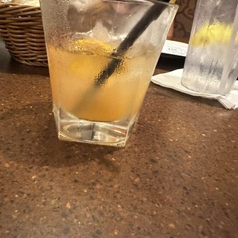 Chateau Restaurant - a woman sitting at a table with a glass of lemonade - Italian Near Me - Waltham, Massachusetts
