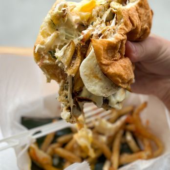 Frita Batidos - Fish Frita with Tropical Slaw, over easy egg, and Muenster cheese. Shoestring Fries that come with. - Cuban Near Me - Ann Arbor, Michigan
