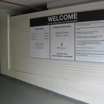 Deep Throat Parking Garage - a sign noting hours and prices - Parking Near Me - Rosslyn, Virginia