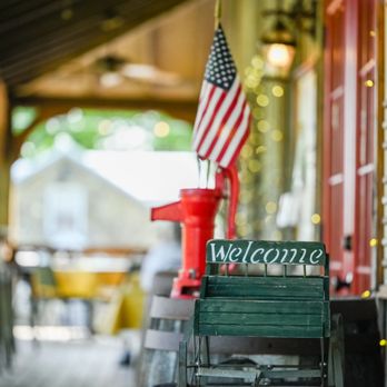 Elvira's Cafe - a wooden bench with a welcome sign - American Near Me - Sevierville, Tennessee
