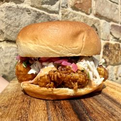 Bayside Fresh Market - October 2026 Sandwich of the Month:  Korean BBQ Crispy Chicken, with house-made sauce, slaw, pickled onions, cilantro, on a Hawaiian bun.