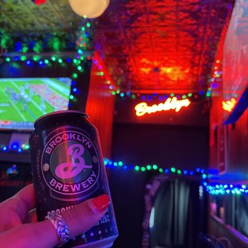 The Little Whiskey - a person holding a can of beer - Pubs Near Me - Bushwick, New York