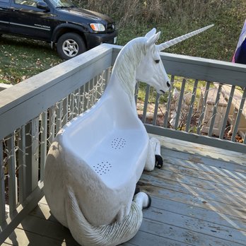 Staggering Unicorn Winery - a white horse sitting on a porch - Wineries Near Me - Athens, Pennsylvania