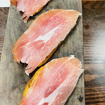 Dos Olivos Market Harlingen - hree slices of bacon on a cutting board - Wine Bars Near Me - Harlingen, Texas Dos Olivos Market Harlingen - hree slices of bacon on a cutting board - Wine Bars Near Me - Harlingen, Texas