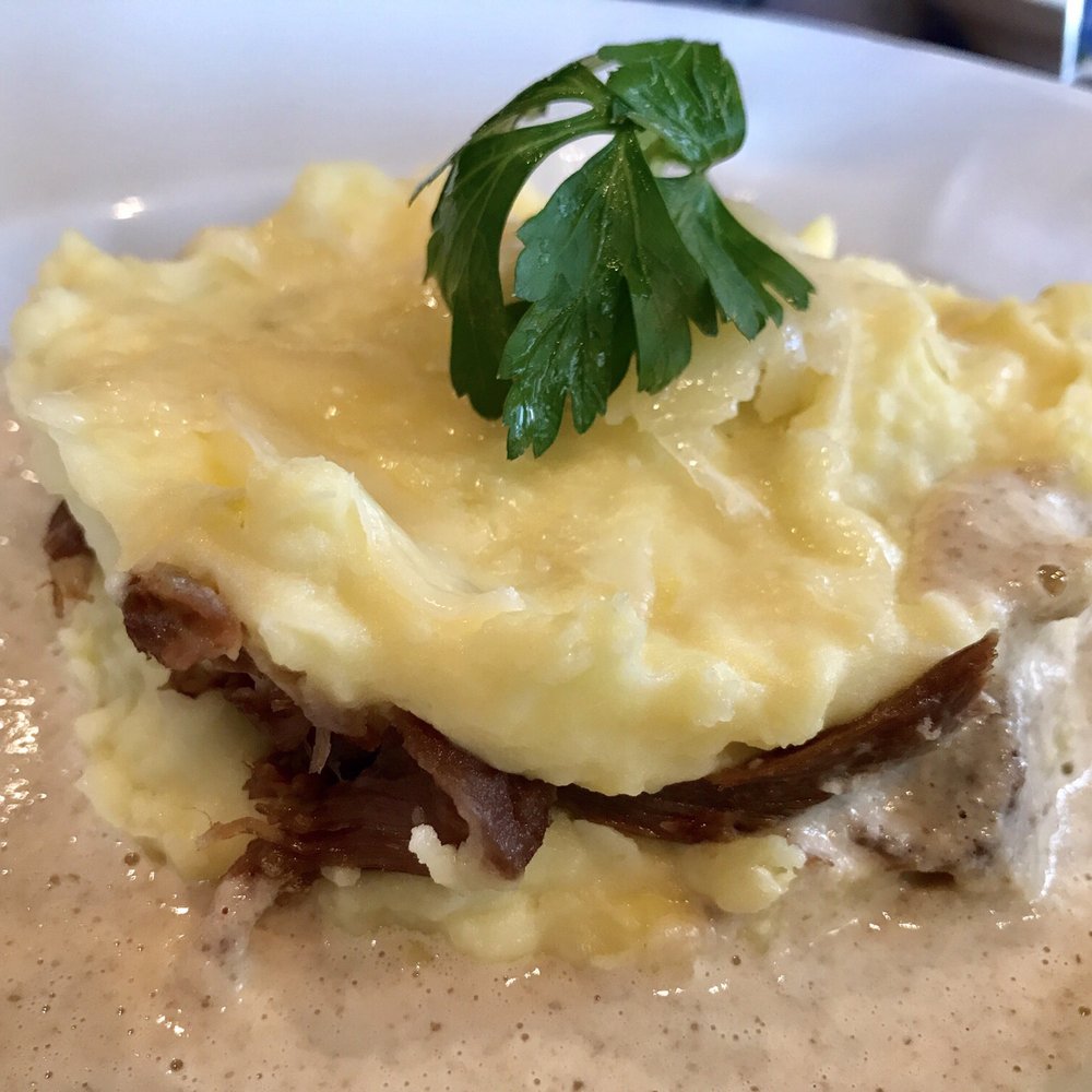L'Escapade - Duck confit hugged by mashed potato and topped with mushroom souse. - Brasseries Near Me - Paris, 75 L'Escapade - Duck confit hugged by mashed potato and topped with mushroom souse. - Brasseries Near Me - Paris, 75