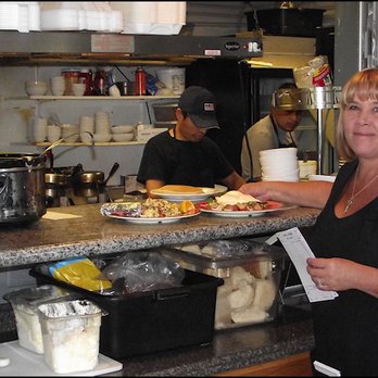 Mandy's Breakfast House - My friendly server, Beverly, picks up a couple of breakfast orders from the kitchen window, with a smile. - Breakfast & Brunch Near Me - Sonora, California
