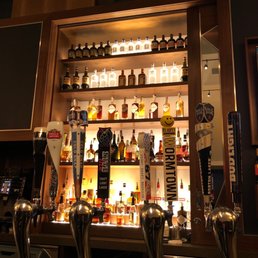 a row of beer taps on a bar