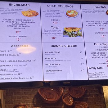 Mexicana - Menu - A digital menu board features Mexican cuisine options, including enchiladas, chile rellenos, fajitas, and various drinks and beers, with prices listed. - Mexican Near Me - Berkeley, California
