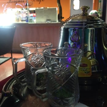 Habibi Cafe - The mint tea presentation along with the painted wall behind the counter. - Hookah Bars Near Me - San Antonio, Texas