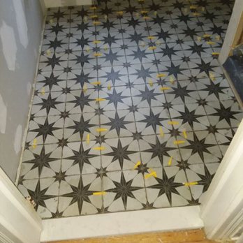 Juarez Construction - a bathroom with a tiled floor - General Contractors Near Me