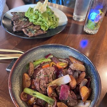 Brasas Peru Bistro Bar - Lomo Brasas in the front dish and grilled skirt steak in the back dish - Peruvian Near Me - Huntington, New York Brasas Peru Bistro Bar - Lomo Brasas in the front dish and grilled skirt steak in the back dish - Peruvian Near Me - Huntington, New York
