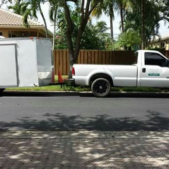 UR Way Lawn Service - a white truck with a trailer - Tree Services Near Me