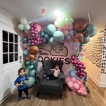 Twin Kookies & Sweets - a little boy standing in front of a balloon arch - Shaved Ice Near Me - Smyrna, Georgia