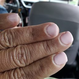 Lumpy gel manicure with uneven nails & shredded cuticles.