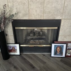 Fireplace & BBQ Service - This is before. Old fake logs. Yucky stuff inside.