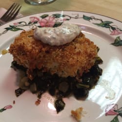 Breaded cod over fresh collars greens.