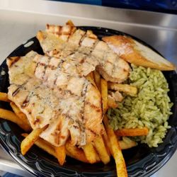 Pacifico Charbroiled Fish - Fresh grilled salmon with garlic butter sauce, cilantro lime rice, and seasoned fries.