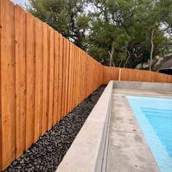 OSR Exteriors - After. We did not replace the fence rather we fixed, straightened, stained and added Mexican beach pebble.