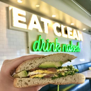NU Kitchen - a person holding a sandwich in their hand - Breakfast & Brunch Near Me - Somerville, Massachusetts