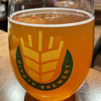 Divots Downtown - a glass of beer on a table - Breweries Near Me - Norfolk, Nebraska Divots Downtown - a glass of beer on a table - Breweries Near Me - Norfolk, Nebraska