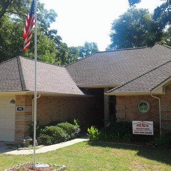 Reid's Roofing - a house with a flag pole in front of it - Roofing Near Me Reid's Roofing - a house with a flag pole in front of it - Roofing Near Me