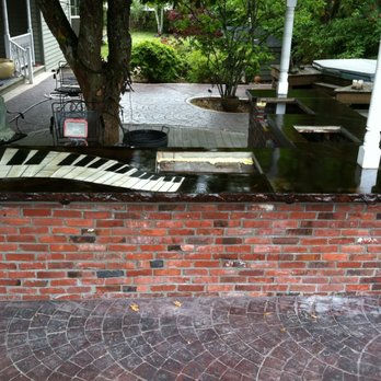 Derouin Concrete - a piano on a brick patio - General Contractors Near Me Derouin Concrete - a piano on a brick patio - General Contractors Near Me