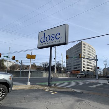 Dose - a street corner with a sign that says dose - Coffee & Tea Near Me - Nashville, Tennessee