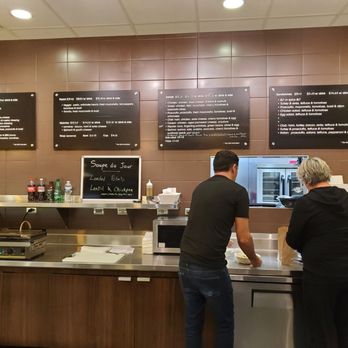 Maison Darras - a man and a woman standing in front of a counter - Sandwiches Near Me - Saint Paul, Minnesota