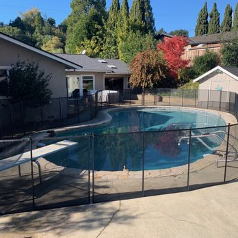 Clearly Different Inc - a pool with a fence around it - Pool Cleaners Near Me - Danville, California