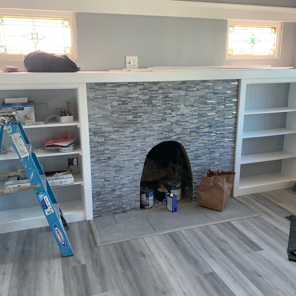 Royal Floors - a living room with a fireplace and built in shelvings - General Contractors Near Me - Oakland, California Royal Floors - a living room with a fireplace and built in shelvings - General Contractors Near Me - Oakland, California