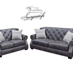 Fredo , high, tufted back with matching button , serious looking in a big living room,shown fabric with leather look and crome neilhead
