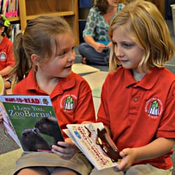Shallowford Presbyterian School - SPS First Graders, Ella Keith and Amelia Moseley, enjoy sharing books with each other during Library time.
