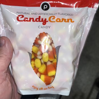 Publix - a hand holding a bag of candy corn - Grocery Near Me - Boynton Beach, Florida