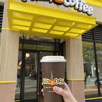 Philz Coffee - a hand holding a cup of coffee - Coffee & Tea Near Me - Emeryville, California