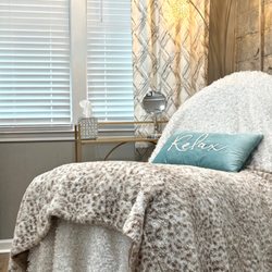Relax in a private treatment suite designed for comfort, luxury, and personalized aesthetic care.
