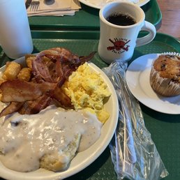 Biscuits with sausage gravy, scrambled eggs, bacons, and tater tots with orange cranberry muffin.  Yum.