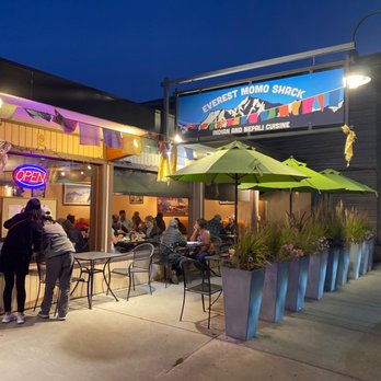 Everest MoMo Shack - people sitting at tables outside at night - Indian Near Me - Jackson, Wyoming Everest MoMo Shack - people sitting at tables outside at night - Indian Near Me - Jackson, Wyoming