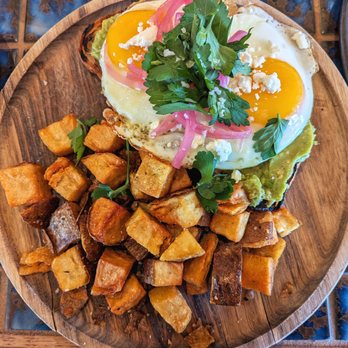 Second Bar & Kitchen At East Austin Hotel - Avacado Toast with Cilantro on top and Breakfast Potatoes - Breakfast & Brunch Near Me - Austin, Texas Second Bar & Kitchen At East Austin Hotel - Avacado Toast with Cilantro on top and Breakfast Potatoes - Breakfast & Brunch Near Me - Austin, Texas
