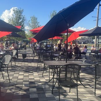 Riva Italian Restaurant - This is part of the patio, over looking the causeway. The block, fire places. Umbrellas give this place a spectacular feeling. - Pizza Near Me - Port Stanley, Ontario