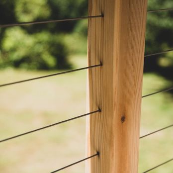 Spruce Properties - a closeup of a wooden post and wire - General Contractors Near Me - Poulsbo, Washington Spruce Properties - a closeup of a wooden post and wire - General Contractors Near Me - Poulsbo, Washington