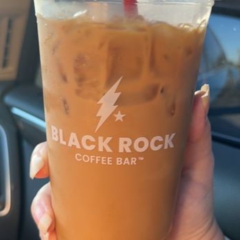 Black Rock Coffee Bar - a hand holding a cup of iced coffee - Coffee & Tea Near Me - Glendale, Arizona Black Rock Coffee Bar - a hand holding a cup of iced coffee - Coffee & Tea Near Me - Glendale, Arizona