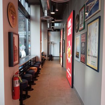 Raising Cane's Chicken Fingers - a row of stools in a restaurant - Fast Food Near Me - Chicago, Illinois