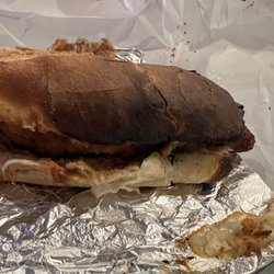 Joe Santucci's Square Pizza - Burnt black chicken parm sandwich. the other side of roll was melted into the paper so had rip apart