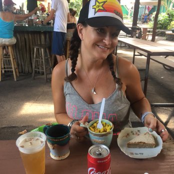 Karuna Foods - a woman sitting at a table with food and drinks - Food Stands Near Me - Pāhoa, Hawaii Karuna Foods - a woman sitting at a table with food and drinks - Food Stands Near Me - Pāhoa, Hawaii