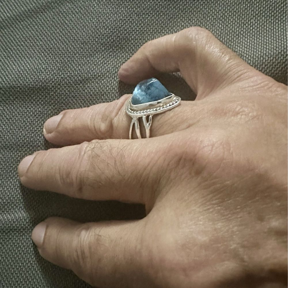 10k blue topaz stone from a vintage ring set on a new modern band. 10k blue topaz stone from a vintage ring set on a new modern band.