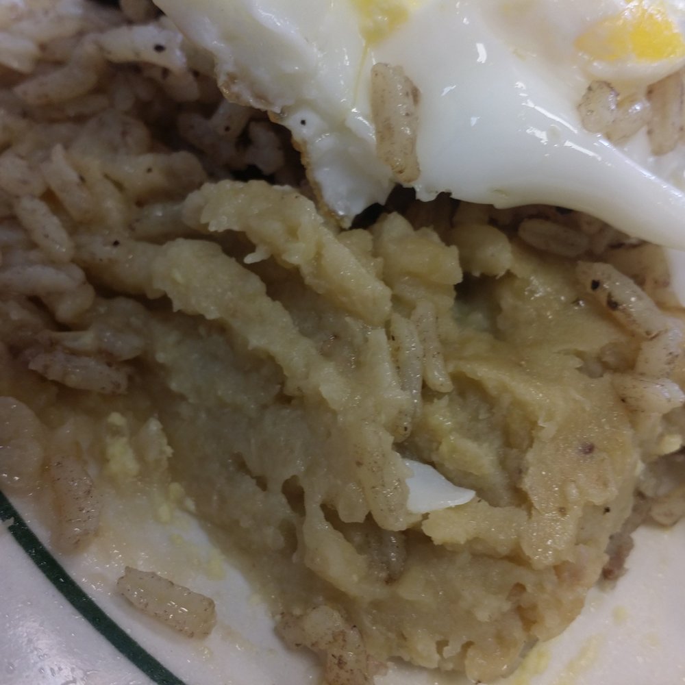 a plate of food with rice and an egg a plate of food with rice and an egg